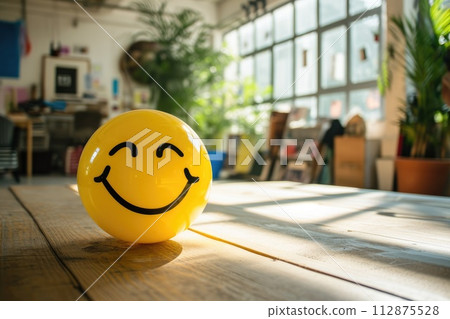 AI-generated content. A Yellow Smiling Ball Can Promote a Positive Work Environment. 112875528