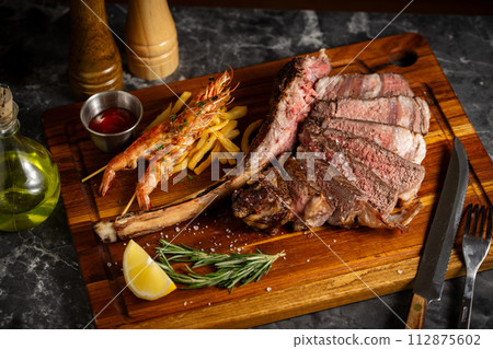 surf and turf, tomahawk steak and shrimps surf and turf, tomahawk steak and shrimps 112875602