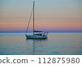 Yacht floating in the sunset in southern France 112875980