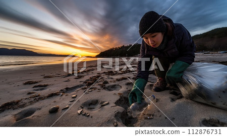 AI-generated content. Volunteer collecting trash along a sandy beach with striking streaks of sunset colors in the sky. 112876731