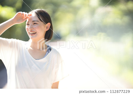 Smiling young woman running in sportswear Smiling young woman running in sportswear 112877229