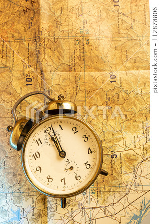 old mechanical clock and world map 112878806