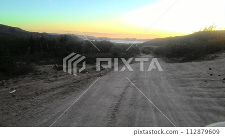 road in the field at sunset road in the field at sunset 112879609