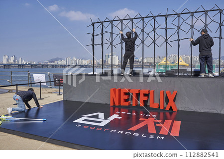 Workers set up promotional stand for 3 Body Problem Netflix science fiction television series in Seoul, South Korea 112882541