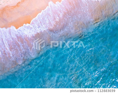 Amazing Top view sea beach landscape background,Summer sea waves crashing on sandy shore seascape background,High angle view ocean nature background Amazing Top view sea beach landscape background,Summer sea waves crashing on sandy shore seascape background,High angle view ocean nature background 112883039