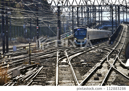 Japan's Yokohama cityscape View of trains and shining rails from the Nagatsuta Station side 112883286