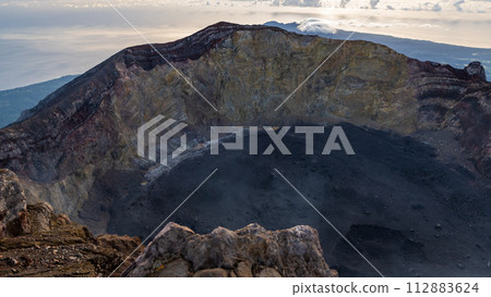 Sunrise at the top of the Ijen volcano. Panoramic view of East Java, Indonesia. The background of the natural landscape. 112883624