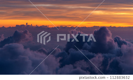 Beautiful sunset sky above the clouds with dramatic light. Shooting from the top of the Agung volcano Beautiful sunset sky above the clouds with dramatic light. Shooting from the top of the Agung volcano 112883632
