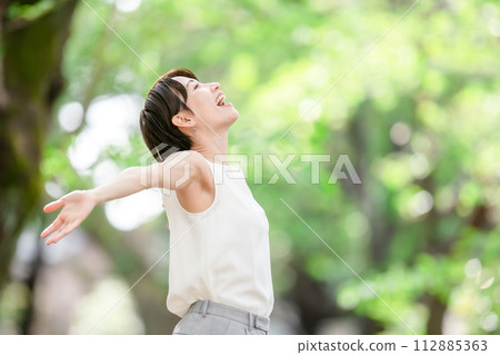 Woman stretching, deep breathing, fresh greenery Woman stretching, deep breathing, fresh greenery 112885363