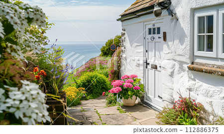 White coastal cottage in the English countryside style by the seaside White coastal cottage in the English countryside style by the seaside 112886375