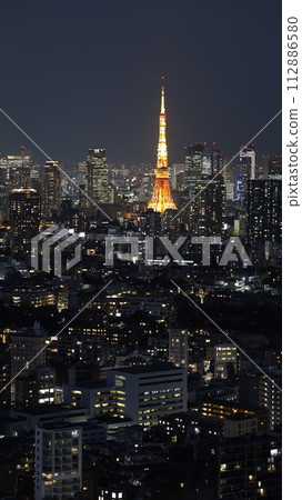 Tokyo Tower seen from the observation space of Ebisu Garden Place Tower 112886580