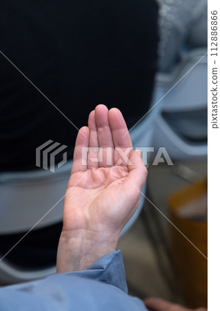 An outstretched hand with an open palm. 112886866