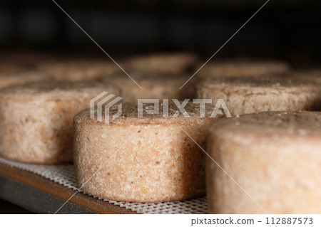 Production of artisanal cheese. In the curing process. 112887573