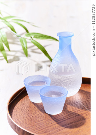 Transparent sake bottle and choko sake bottle where light shines through - Japanese sake image Transparent sake bottle and choko sake bottle where light shines through - Japanese sake image 112887729
