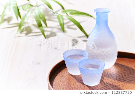 Transparent sake bottle and choko sake bottle where light shines through - Japanese sake image Transparent sake bottle and choko sake bottle where light shines through - Japanese sake image 112887730