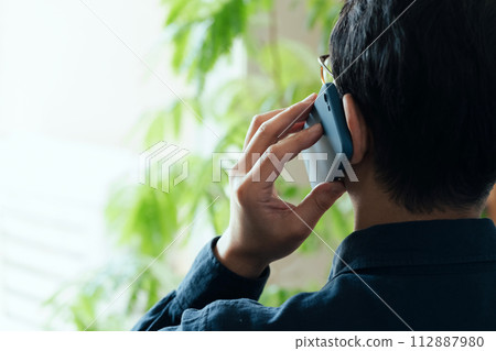 A man calling on a smartphone 112887980