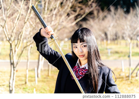 High school girl holding a sword 112888075