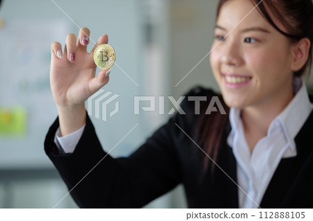 Business woman look at Bitcoin btc cryptocurrency as saving bank account currency in finance exchange trade for digital money gold technology cash. Person invest in electronic online payment market Business woman look at Bitcoin btc cryptocurrency as saving bank account currency in finance exchange trade for digital money gold technology cash. Person invest in electronic online payment market 112888105
