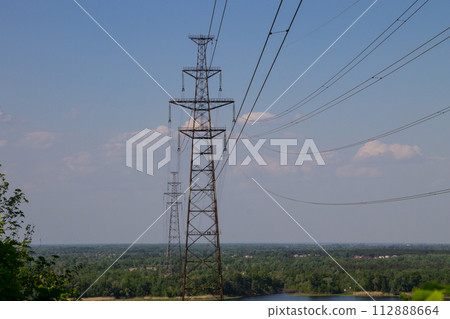 High voltage power line against blue sky High voltage power line against blue sky 112888664