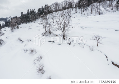 Drone photo: Rice terraces in Gamo, Niigata Prefecture in winter 112889450