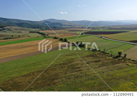 Aerial countryside view of agriculture fields, farmland, rural scenery by drone 112890491