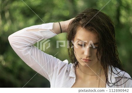 Portrait of serious brunette girl with wet hair 112890942