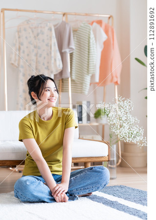 Young woman relaxing in the living room Young woman relaxing in the living room 112891692