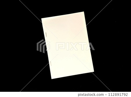 bound paper on black background bound paper on black background 112891792