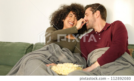 Woman putting popcorn in her boyfriend's mouth 112892080