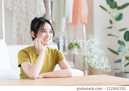 Young woman relaxing in the living room Young woman relaxing in the living room 112892292