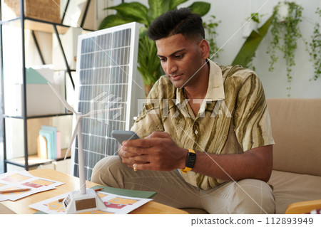 Renewable energy sales manager answering text messages from clients Renewable energy sales manager answering text messages from clients 112893949