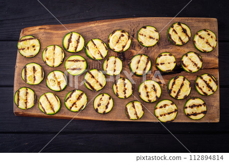 Healthy vegetarian food . Grilled green zucchini . Healthy vegetarian food . Grilled green zucchini . 112894814