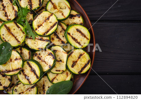Healthy vegetarian food . Grilled green zucchini . Healthy vegetarian food . Grilled green zucchini . 112894820