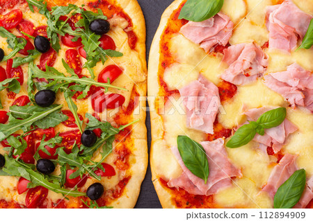 Assortment of Traditional italian pizza with vegetables olives tomatoes and ham Assortment of Traditional italian pizza with vegetables olives tomatoes and ham 112894909