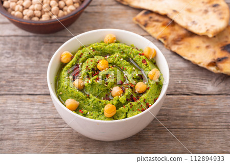 Declicious food from chickpea - green hummus. 112894933