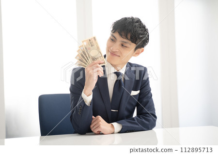 商人對手裡的現金感到滿意 商人對手裡的現金感到滿意 112895713