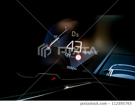 Modern fuel gauge in car dashboard 112895765