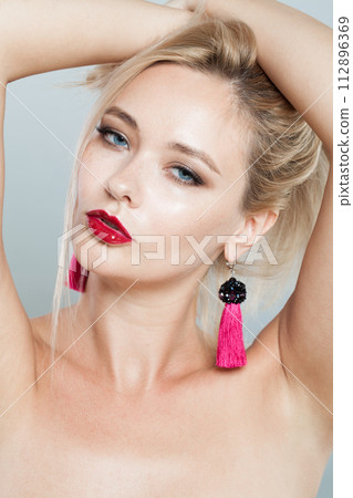 Elegant woman face close-up. Blonde model with fresh clear skin and healthy silky hair  112896369