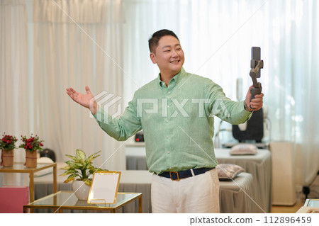 Excited Korean spa salon owner filming content to upload on social media Excited Korean spa salon owner filming content to upload on social media 112896459