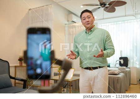 Wax salon owner filming content for social media 112896460