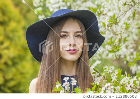 Spring brunette woman portrait. Beautiful female model with long hair and make-up  112896508