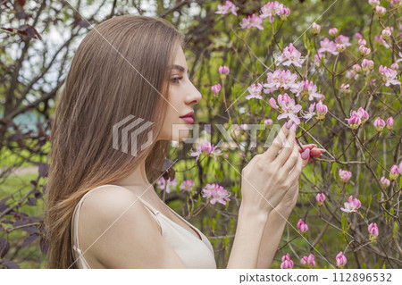 Good-looking brunette woman portrait. Beautiful female model with long hair and make-up 112896532