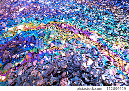 Leaked Gasoline Oil Slick or Petrol Rainbow Enviromental leak On Tarmac Road 112896629