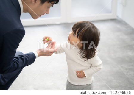 Child giving a present to his father on the way to work Child giving a present to his father on the way to work 112896636