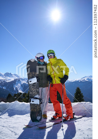 Skier and Snowboarder Enjoying Mountain View Skier and Snowboarder Enjoying Mountain View 112897482