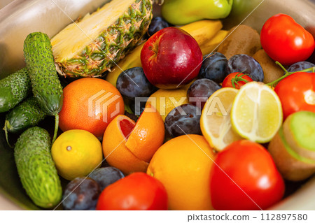 Fruits, vegetables and greens lie on the table, natural light Fruits, vegetables and greens lie on the table, natural light 112897580