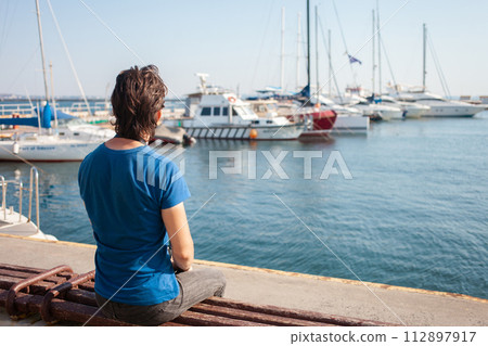 Tourist in seaport. Yachts in the parking lot, seaport in Odessa, Black Sea. Sailing, rich lifestyle, beach holidays. Business rental of boats, riding tourists on waves. sunny day, wind. portrait 112897917