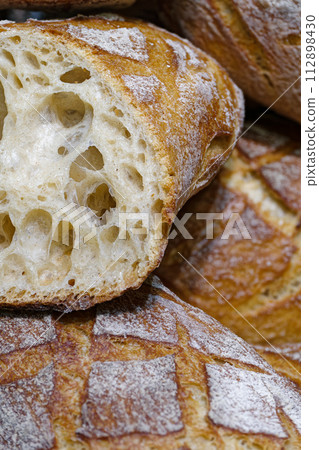 Large loaves of freshly baked wheat bread Large loaves of freshly baked wheat bread 112898430