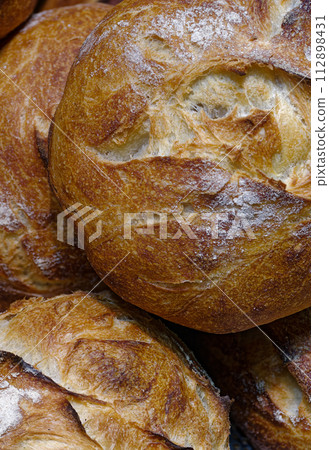 Large loaves of freshly baked wheat bread 112898431