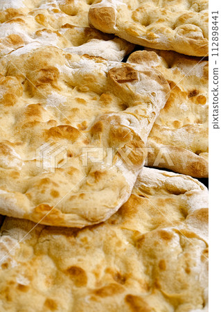 Focaccia, traditional Italian flat wheat bread Focaccia, traditional Italian flat wheat bread 112898441